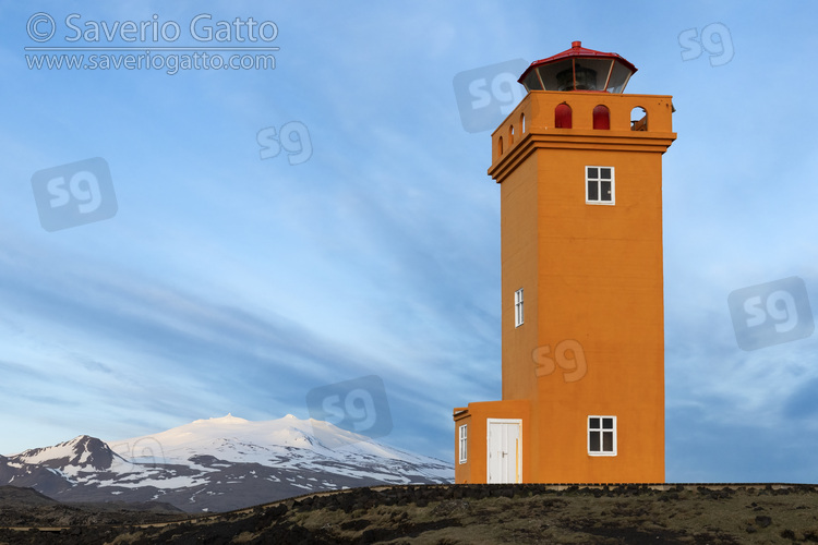 Svortuloft Lighthouse, view of the lighthouse with a snow-capped mountain in the background