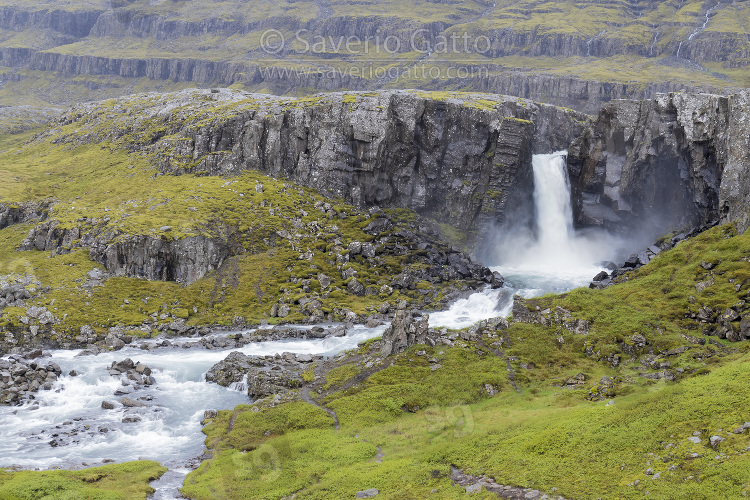 Icelandic landscape, scenery with waterfall among rocks